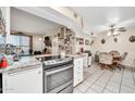 Bright kitchen with granite countertops and an open layout leading to the dining area at 13428 N Hawthorn Dr, Sun City, AZ 85351