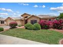 Beautiful single-story home with lush landscaping and a well-maintained lawn at 14835 N 41St Pl, Phoenix, AZ 85032