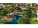 Community basketball court surrounded by mature trees, providing shade and a pleasant playing environment at 15652 W Pershing St, Surprise, AZ 85379
