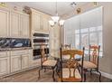 Eat-in kitchen features granite counters, stainless appliances, tile floor, and custom cabinets at 16217 N 154Th Dr, Surprise, AZ 85374