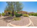 Charming single-story home with desert landscaping, stone accents, and a cozy front entrance at 17359 W Calistoga Dr, Surprise, AZ 85387