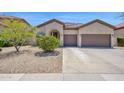 Beautiful single-story home with a well-maintained yard, mature landscaping, and a two-car garage at 18455 W San Carlos Dr, Goodyear, AZ 85338