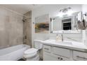 Bathroom featuring a shower over tub with grey tile, white vanity with marble countertops at 2021 E Osborn Rd # 9, Phoenix, AZ 85016
