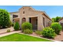 Charming single-story home featuring lush landscaping and a covered porch at 20563 W Edgemont Ave, Buckeye, AZ 85396