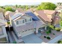 Aerial view of home featuring solar panels, mature landscaping, a concrete driveway, and a welcoming front porch at 20722 N 38Th St, Phoenix, AZ 85050