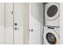 Efficient laundry area with a stacked washer and dryer unit, perfect for saving space in this home at 2313 E Hidalgo Ave, Phoenix, AZ 85040
