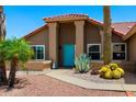 Charming Southwestern-style home with a vibrant turquoise door and desert plants at 2488 Leisure World --, Mesa, AZ 85206