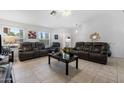 Spacious living room featuring tile floors and plush leather seating, great for entertaining at 2488 Leisure World --, Mesa, AZ 85206