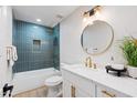 Stylish bathroom featuring blue tile accent wall, shower/tub, and updated vanity with gold fixtures at 3220 W Frankfurt Dr, Chandler, AZ 85226
