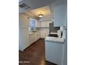 Bright kitchen featuring white cabinets, stainless steel appliances, and modern countertops at 4554 E Paradise Village Pkwy # 149, Phoenix, AZ 85032