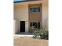 Exterior of the unit with a black door and dual windows with a brick surround at 4701 N 68Th St # 105, Scottsdale, AZ 85251