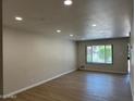 Bright, spacious living room with light wood floors and recessed lighting at 4701 N 68Th St # 105, Scottsdale, AZ 85251