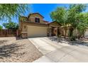 Charming home with a two-car garage, desert landscaping, and a covered porch area at 7031 W Lone Tree Trl, Peoria, AZ 85383