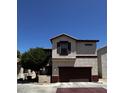 Exterior view of a two-story townhouse with a private garage and neatly kept landscape at 876 S Colonial Dr, Gilbert, AZ 85296