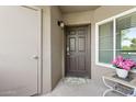 A charming front door with a 'hello summer' doormat and decorative flowers welcomes you at 9450 E Becker Ln # 2067, Scottsdale, AZ 85260