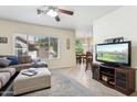 A cozy living room with a comfortable sofa, large windows, and an inviting view into the dining area at 9450 E Becker Ln # 2067, Scottsdale, AZ 85260