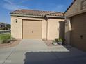 Convenient access to a two-car garage with manicured landscaping and an extended driveway at 10773 W Prickly Pear Trl, Peoria, AZ 85383