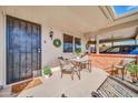 Inviting covered patio with seating area, perfect for outdoor relaxation and enjoying the Arizona weather at 10873 W Clair Dr, Sun City, AZ 85351