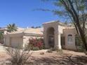 Beautiful home featuring desert landscaping, a tile roof, a three-car garage, and an arched entrance at 11109 W Amelia Ave, Avondale, AZ 85392