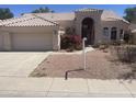 Charming home featuring a tile roof, a three-car garage, and low-maintenance desert landscaping at 11109 W Amelia Ave, Avondale, AZ 85392