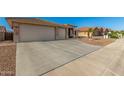 Spacious garage and driveway of a well-maintained house in a quiet neighborhood at 11312 E Newcastle Ave, Mesa, AZ 85209