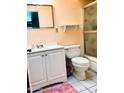 Functional bathroom with white vanity, square mirror, shower and toilet for simple, clean living at 11653 N Hacienda Dr, Sun City, AZ 85351