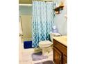 Cozy bathroom featuring a shower-tub combination with stylish blue patterned curtain at 11653 N Hacienda Dr, Sun City, AZ 85351