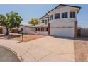 Attractive two-story house showcasing an upper balcony and a spacious two-car garage at 13438 N 18Th Ln, Phoenix, AZ 85029