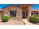 Close up of single-story home showcasing the front door with desert landscaping and a concrete walkway at 13644 W Aleppo Dr, Sun City West, AZ 85375