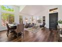 Bright living room featuring high ceilings, large windows, hardwood floors, and elegant furnishings at 15020 N 54Th Pl, Scottsdale, AZ 85254