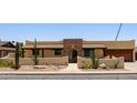 Charming home with desert landscaping, a stone archway, and a tile roof creating a welcoming curb appeal at 1551 E Glencove St, Mesa, AZ 85203