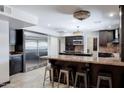 Elegant kitchen boasts custom dark cabinets, granite countertops, and stainless steel appliances at 1551 E Glencove St, Mesa, AZ 85203