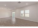 Spacious living room with light walls, wood floors, recessed lighting, and sliding glass door at 1552 N Pueblo Dr, Apache Junction, AZ 85120