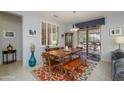 Cozy dining area featuring a modern table, bench seating, and a large window showcasing the outdoors at 16287 W Willow Creek Ln, Surprise, AZ 85374