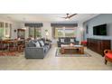 Inviting living room with neutral walls, plush seating, and large windows that provide plenty of natural light at 16287 W Willow Creek Ln, Surprise, AZ 85374