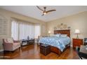 Comfortable main bedroom showcasing warm tones, natural light, and a serene ambiance at 16287 W Willow Creek Ln, Surprise, AZ 85374