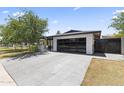 Beautiful single-story home with modern garage door and lush landscaping, creating a welcoming curb appeal at 1861 W Navarro Ave, Mesa, AZ 85202