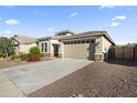 Inviting single-story house with low maintenance landscaping and a convenient two-car garage at 18865 W Mescal St, Surprise, AZ 85388