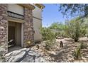 Inviting home entrance featuring stone accents and desert landscape at 19700 N 76Th St # 1103, Scottsdale, AZ 85255