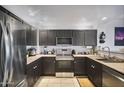 Modern kitchen with stainless steel appliances and stylish dark cabinetry for a sleek, updated look at 19700 N 76Th St # 2057, Scottsdale, AZ 85255