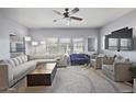 Spacious living room with a large sectional sofa, accent chairs, and modern decor for a comfortable gathering space at 19700 N 76Th St # 2057, Scottsdale, AZ 85255