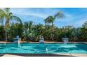 Backyard pool featuring vibrant turquoise water surrounded by lush tropical foliage and decorative tile accents at 1991 W Bartlett Ct, Chandler, AZ 85248