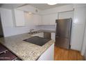 Stylish kitchen featuring granite counters, white cabinets, and stainless steel refrigerator at 2015 E Southern Ave # 23, Tempe, AZ 85282