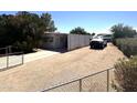 A single story home featuring a metal roof, covered parking and graveled yard at 20644 N 36Th Ave, Glendale, AZ 85308