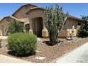 Beautiful home featuring desert landscaping, including a large cactus and rock accents, enhancing the curb appeal at 2092 E Smoke Tree Rd, Gilbert, AZ 85296