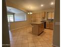 Spacious eat-in kitchen with tile floors, central island and open floor plan at 2092 E Smoke Tree Rd, Gilbert, AZ 85296