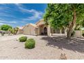 Inviting home with a three-car garage, lush trees, and meticulously maintained landscaping at 20961 N 96Th Dr, Peoria, AZ 85382