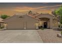 Charming single-story home featuring a three-car garage, tiled roof and well-manicured landscaping at 20961 N 96Th Dr, Peoria, AZ 85382
