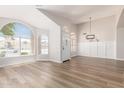Bright, airy living room featuring hardwood floors and large windows filling the space with natural light at 20961 N 96Th Dr, Peoria, AZ 85382