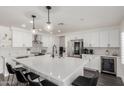 Bright, spacious kitchen with a large island, modern appliances, and sleek white cabinetry at 2438 S Chestnut Pl, Chandler, AZ 85286
